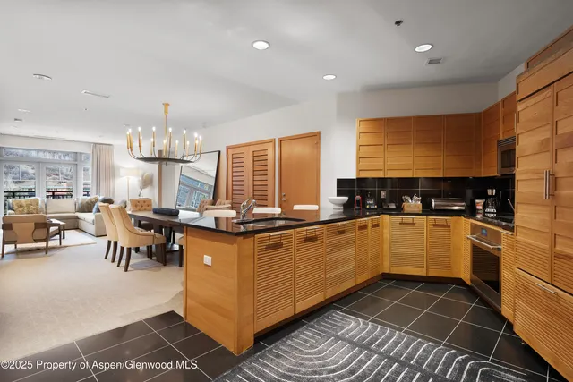 a dining room with furniture and a large window