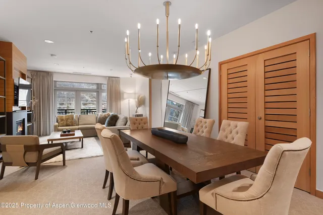 a large living room with kitchen island furniture and a chandelier