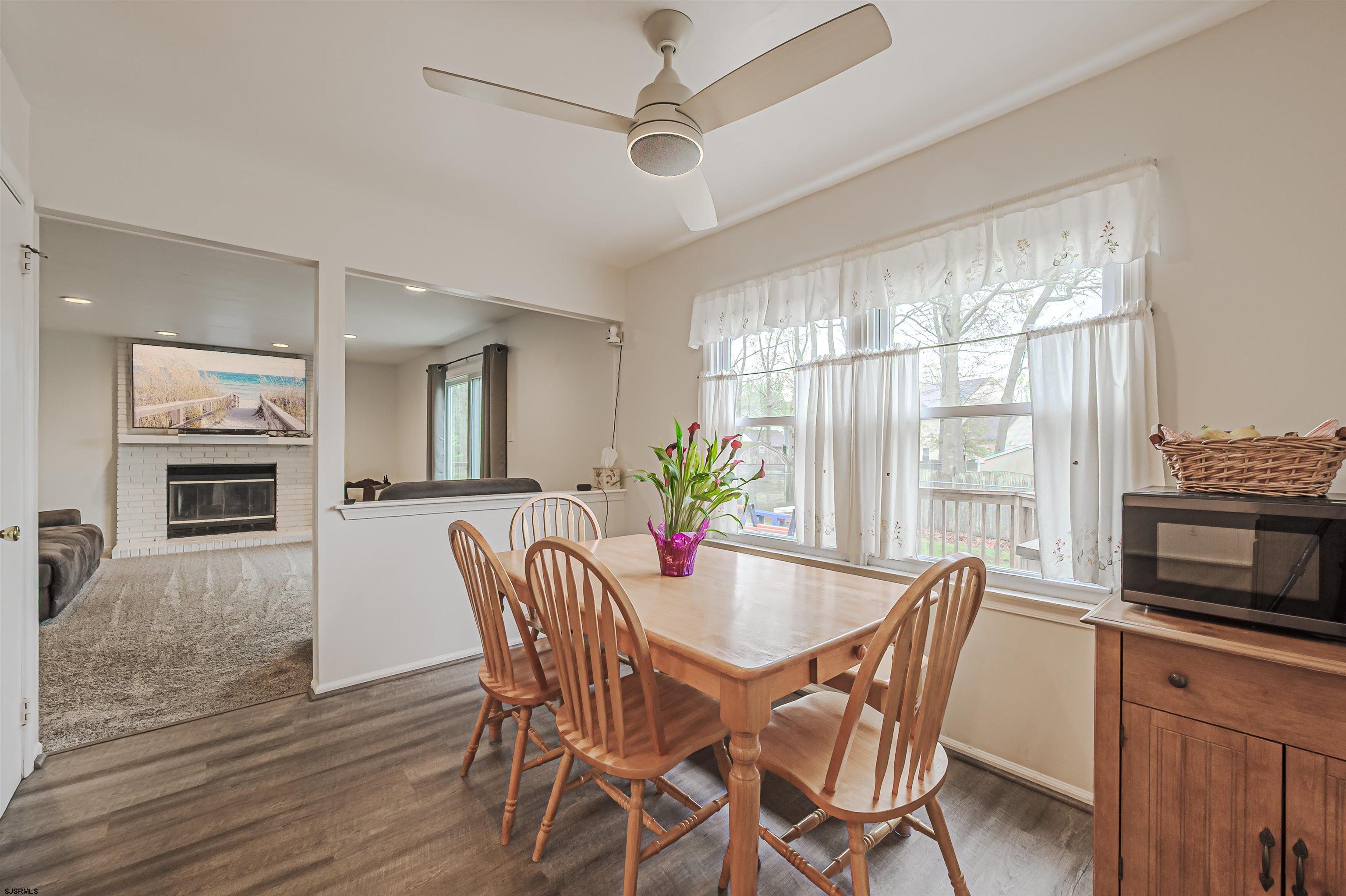 9 Rook Court Egg Harbor Township, NJ 08234 - Photo 11 of 27 a dining room with furniture a window and wooden floor