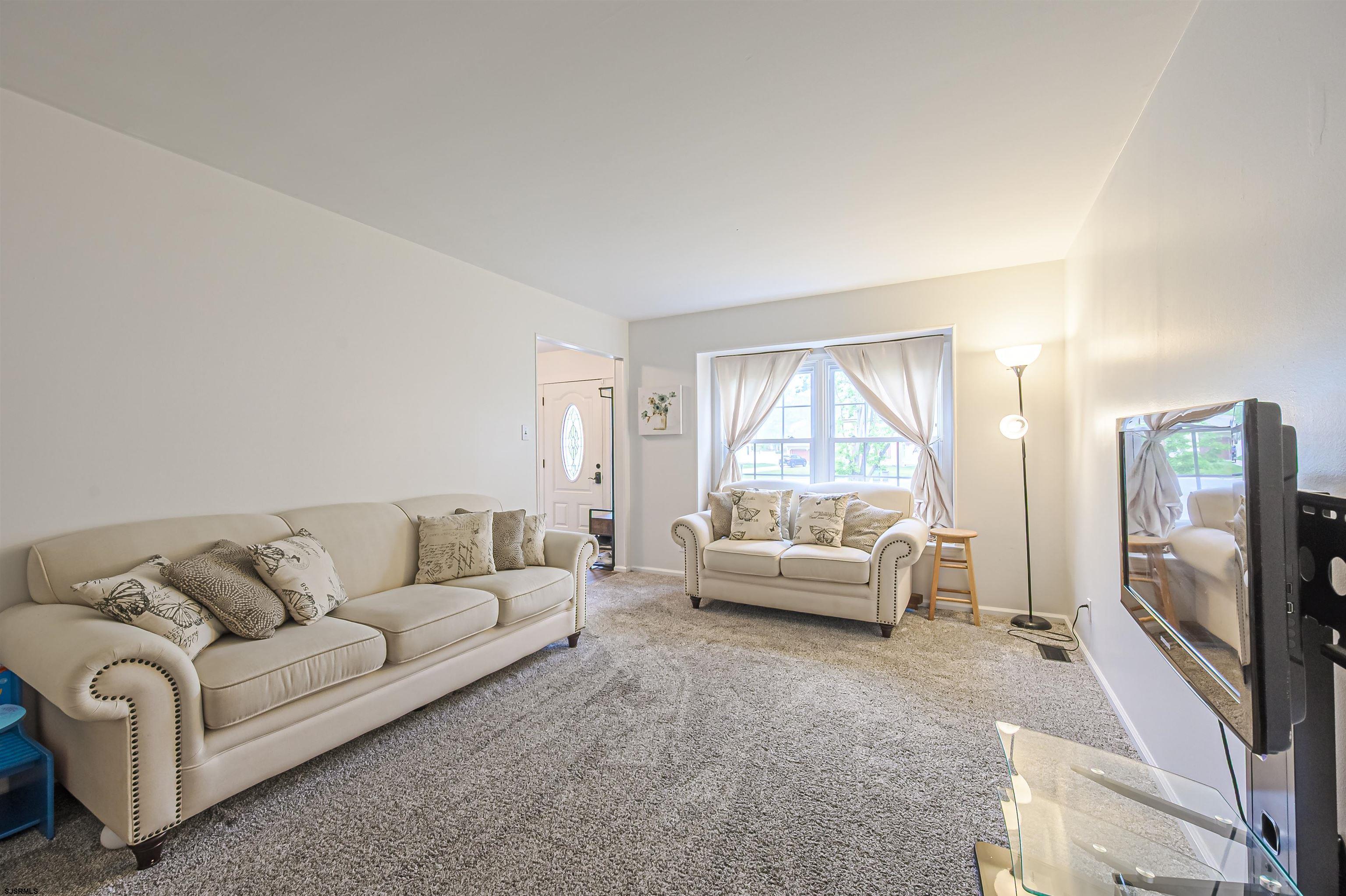 9 Rook Court Egg Harbor Township, NJ 08234 - Photo 2 of 27 a living room with furniture and a flat screen tv
