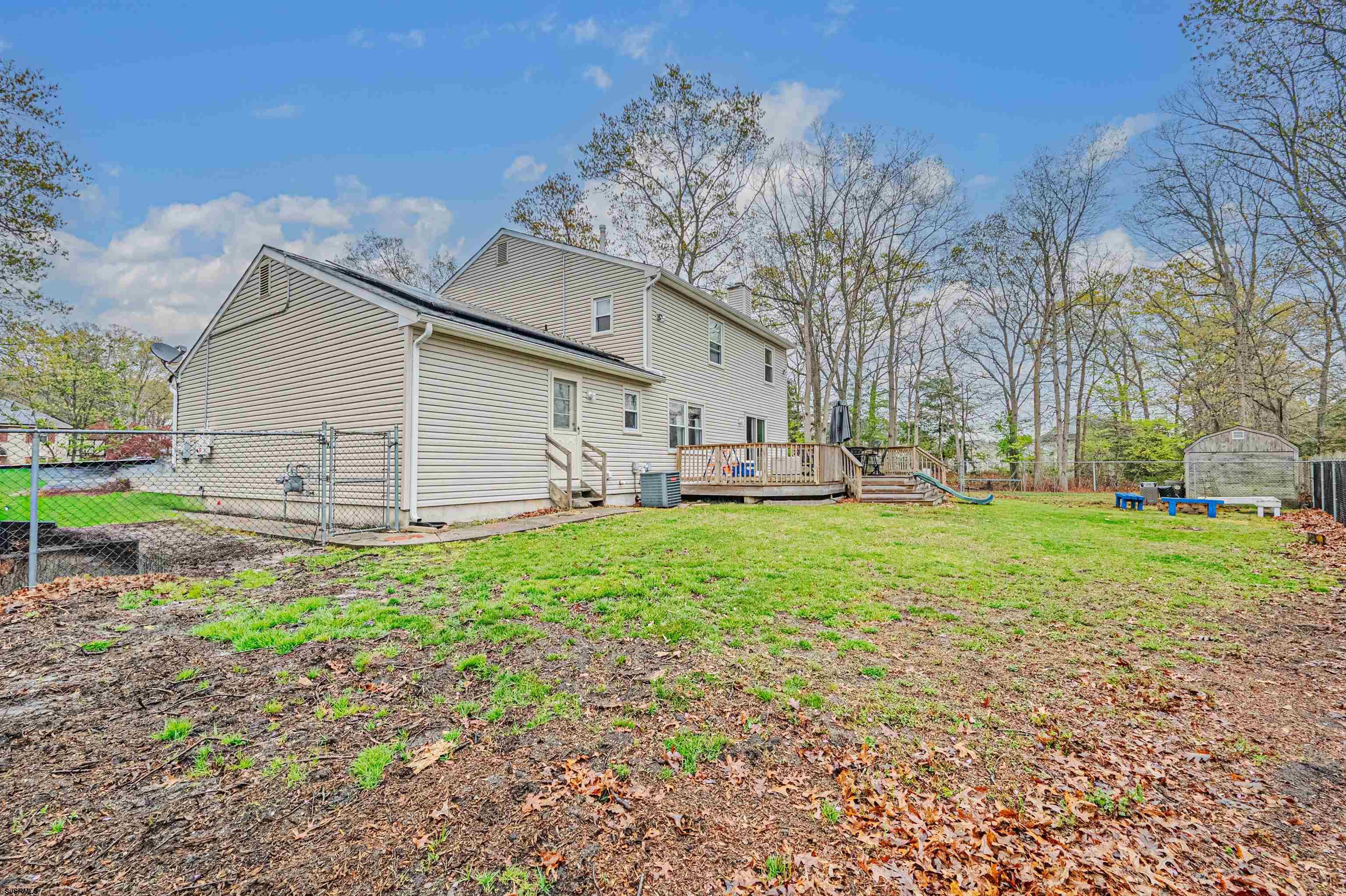 9 Rook Court Egg Harbor Township, NJ 08234 - Photo 25 of 27 a view of backyard of house with outdoor seating and green space