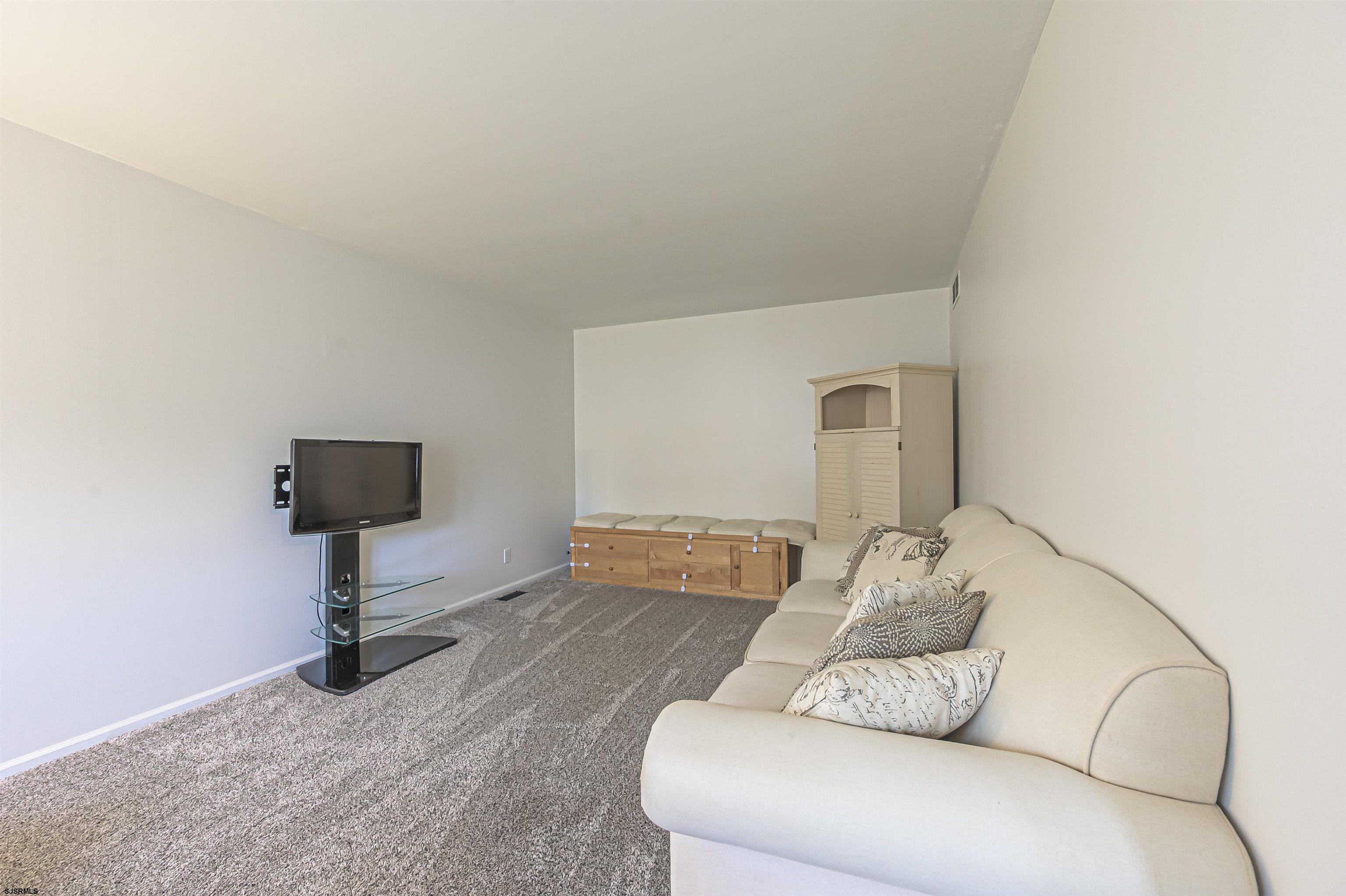 9 Rook Court Egg Harbor Township, NJ 08234 - Photo 3 of 27 a living room with furniture and a flat screen tv