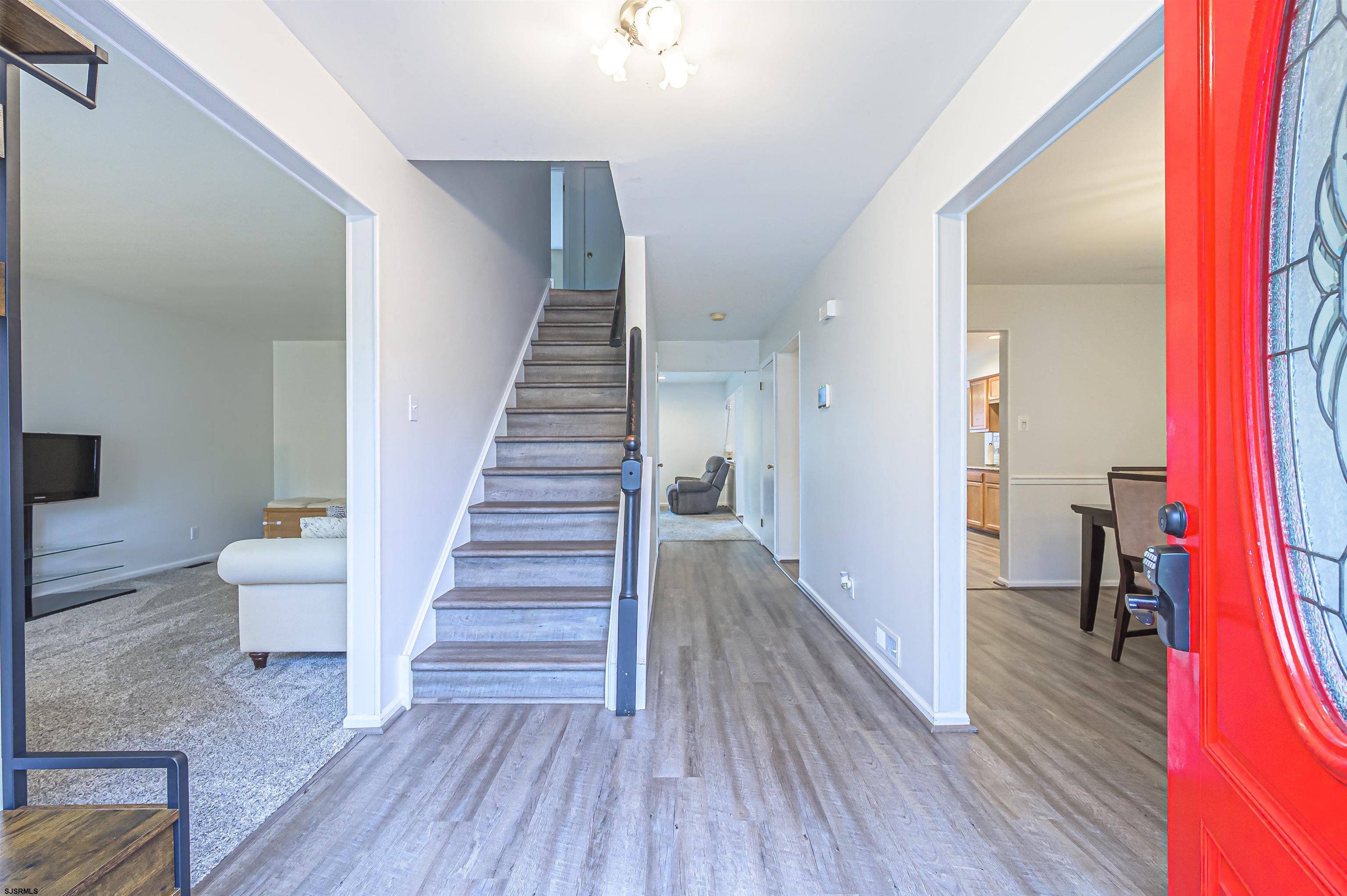 9 Rook Court Egg Harbor Township, NJ 08234 - Photo 5 of 27 a view of a hallway with wooden floor and stairs
