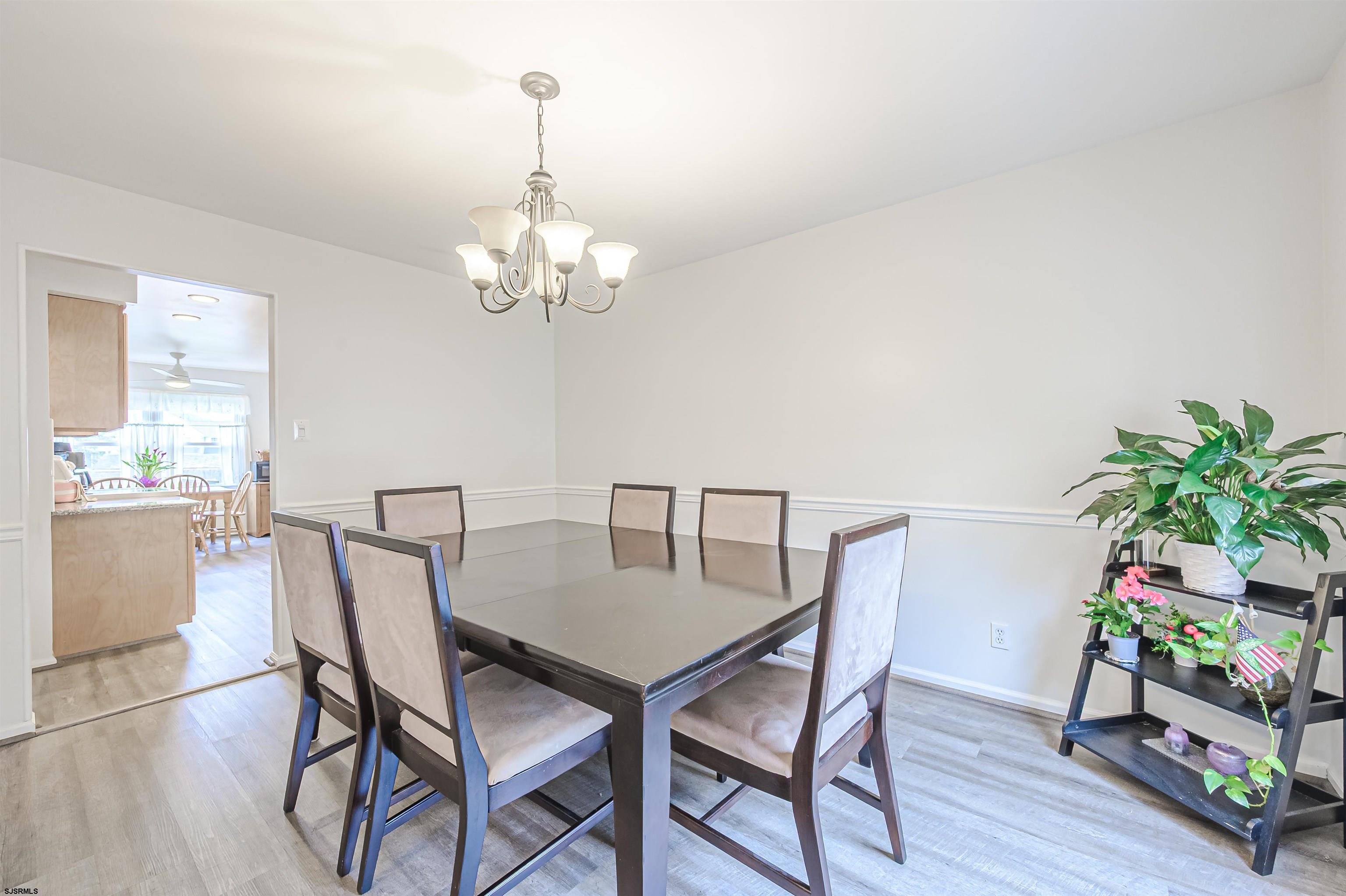 9 Rook Court Egg Harbor Township, NJ 08234 - Photo 7 of 27 a dining room with furniture potted plants and wooden floor