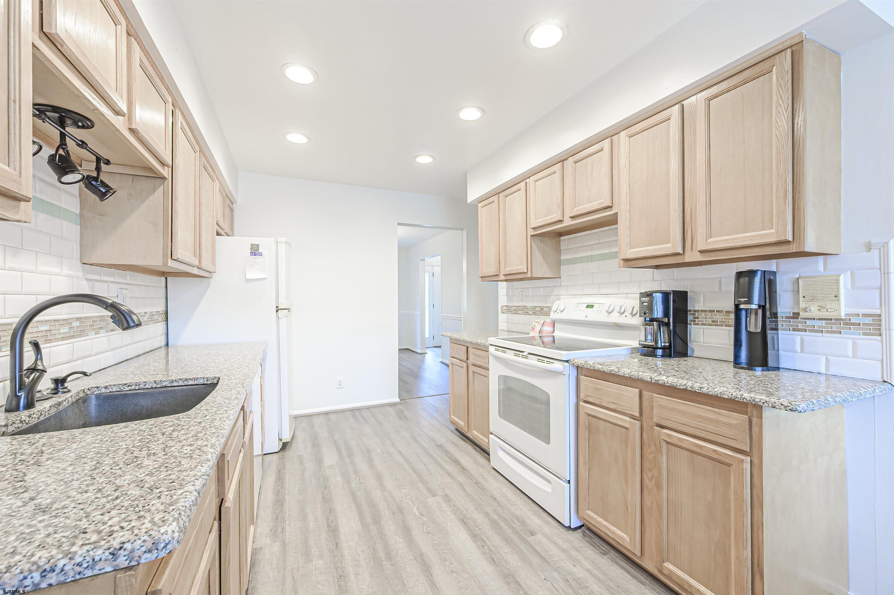 9 Rook Court Egg Harbor Township, NJ 08234 - Photo 9 of 27 a kitchen with granite countertop a sink stainless steel appliances and cabinets