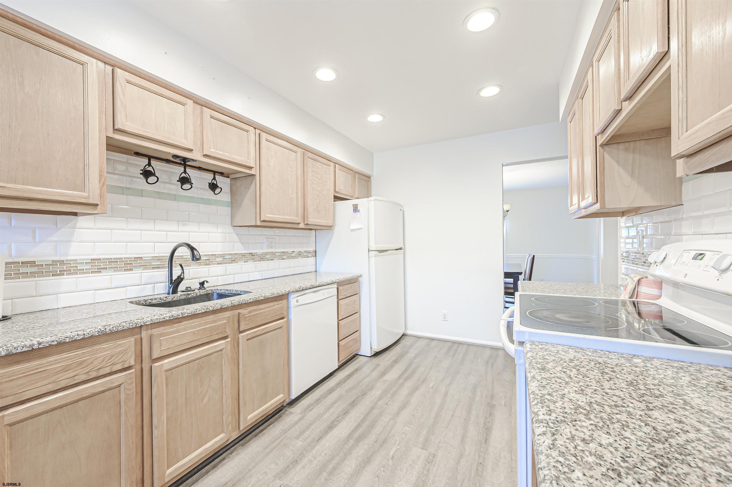 9 Rook Court Egg Harbor Township, NJ 08234 - Photo 10 of 27 a kitchen with a sink stove and cabinets