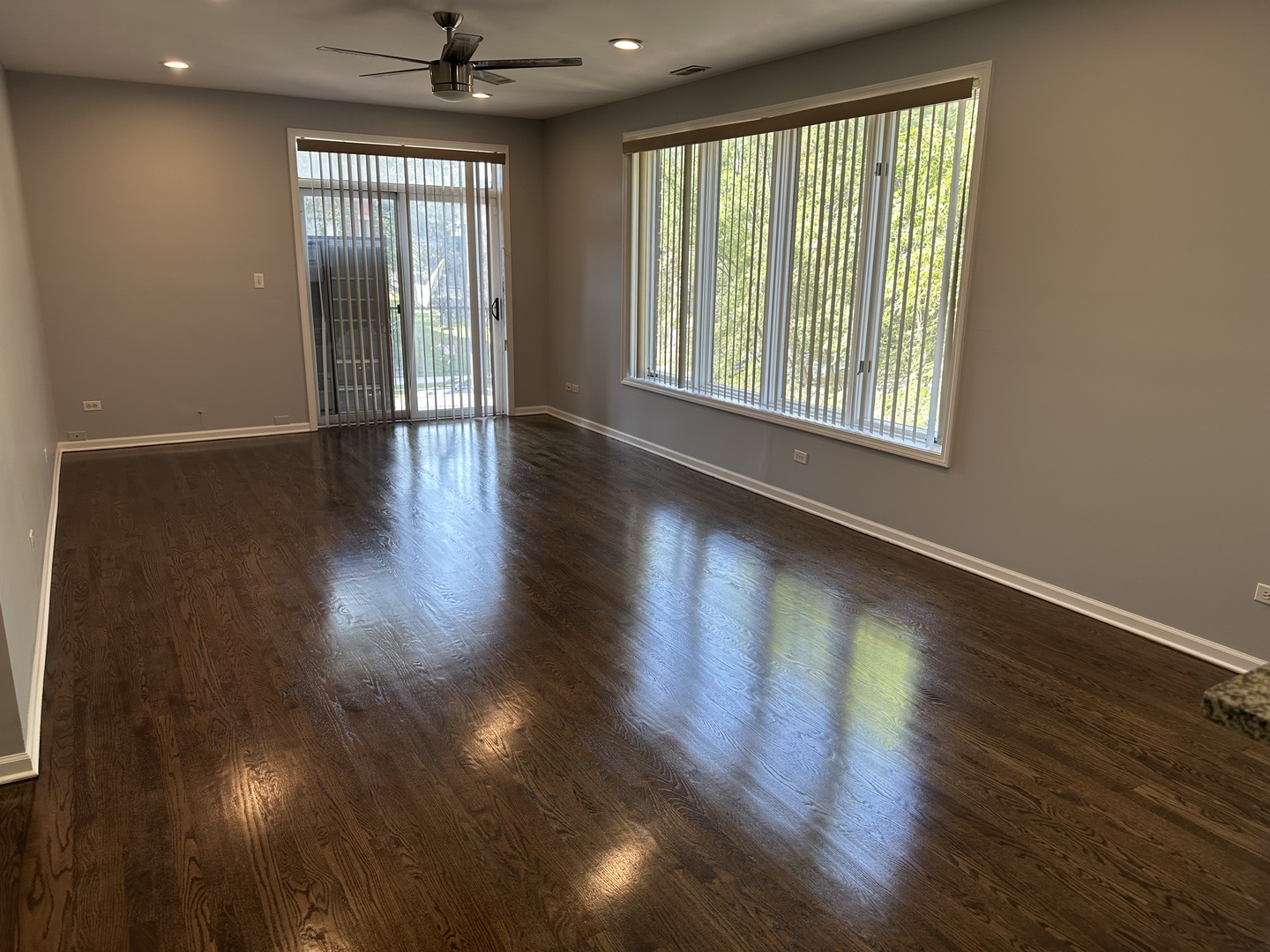 5219 South Michigan Avenue, Unit 2W Chicago, IL 60615 - Photo 5 of 14 an empty room with wooden floor and windows