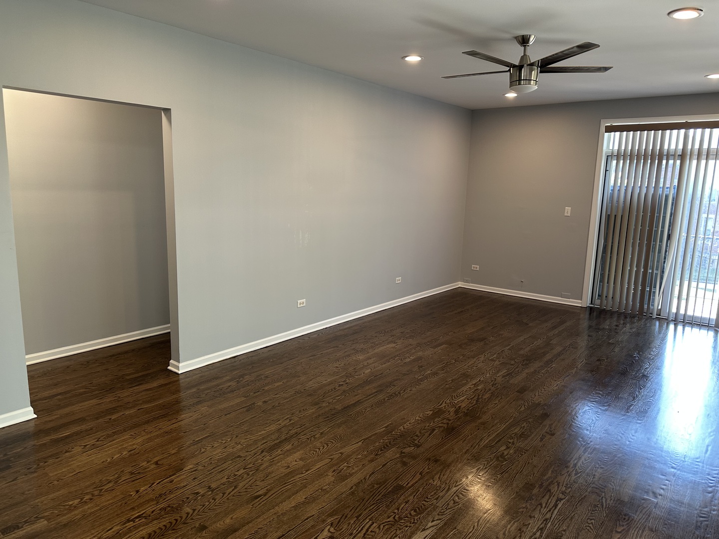 5219 South Michigan Avenue, Unit 2W Chicago, IL 60615 - Photo 6 of 14 an empty room with wooden floor and windows