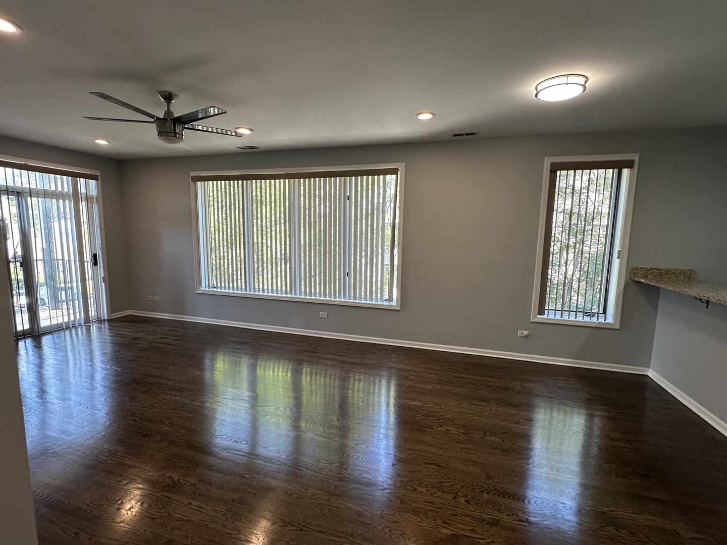 5219 South Michigan Avenue, Unit 2W Chicago, IL 60615 - Photo 7 of 14 a view of an empty room with wooden floor and a window