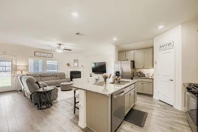 a kitchen with refrigerator cabinets dining table and chairs
