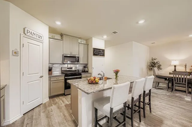a kitchen with a sink stove and cabinets