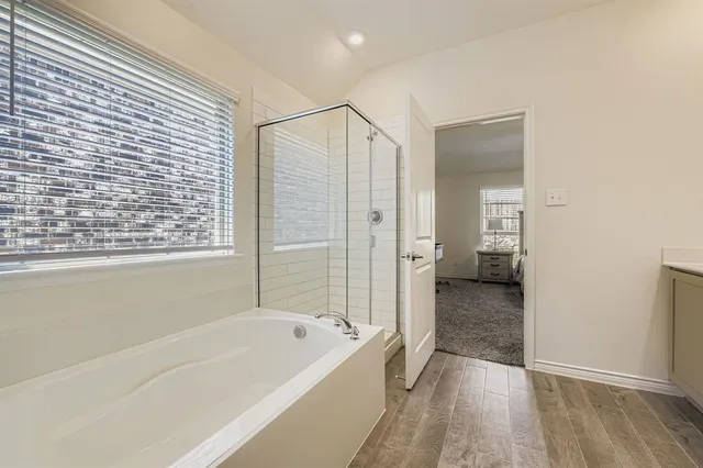 a en suite bathroom with a double vanity sink a mirror and a toilet