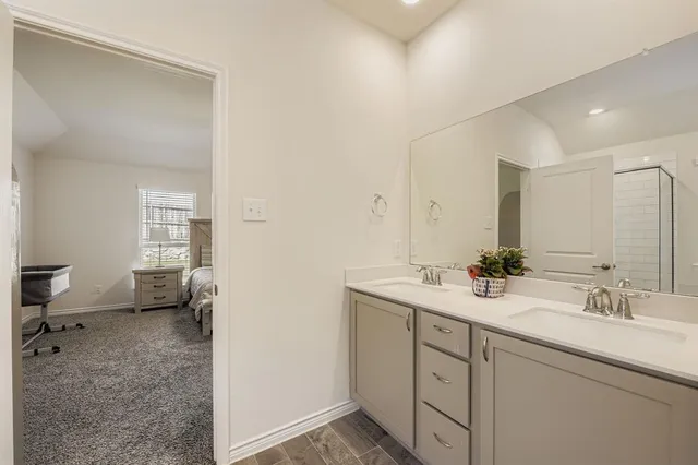 a bedroom with a bed a couch and a window