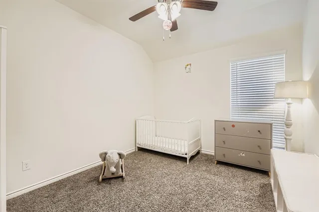 a view of a room with toys and ceiling fan