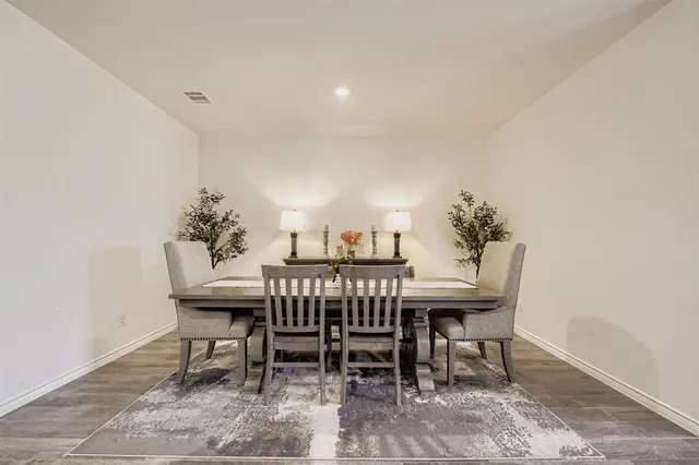a view of a dining room with furniture and a potted plant