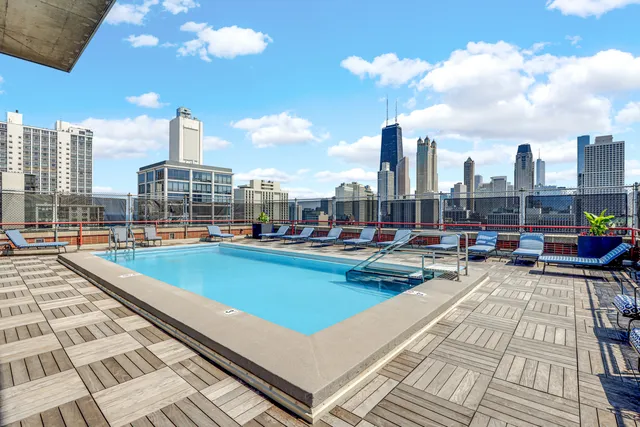 a view of swimming pool with outdoor seating and city view