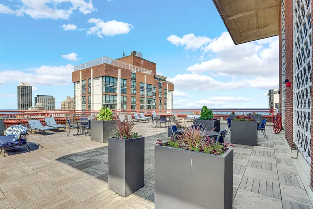 a view of a terrace with seating area and city view