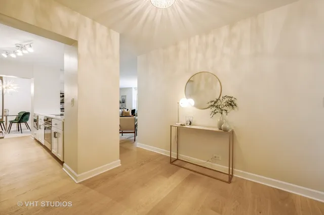 a view of a room with wooden floor and a potted plant