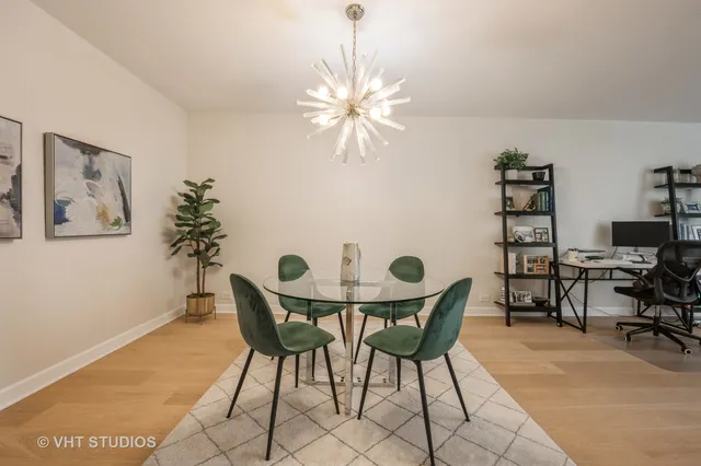 a view of a dining room with furniture and chandelier