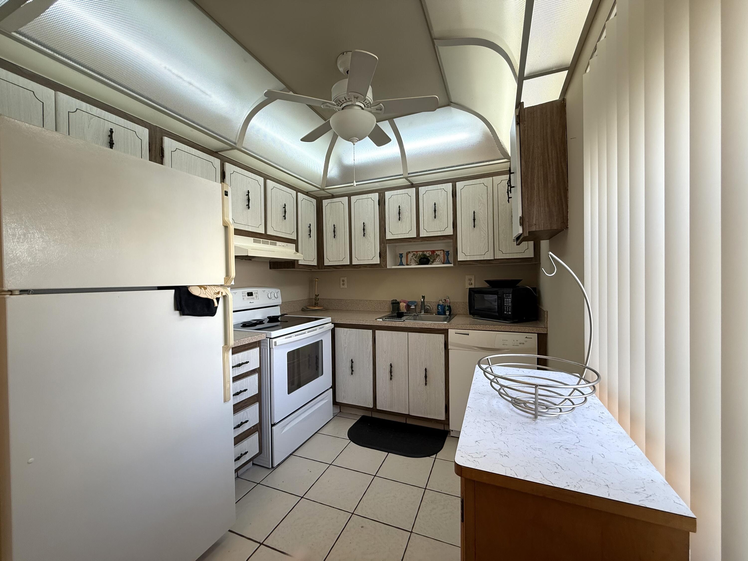 894 Flanders South Delray Beach, FL 33484 - Photo 1 of 16 a kitchen with stainless steel appliances granite countertop a sink stove and refrigerator