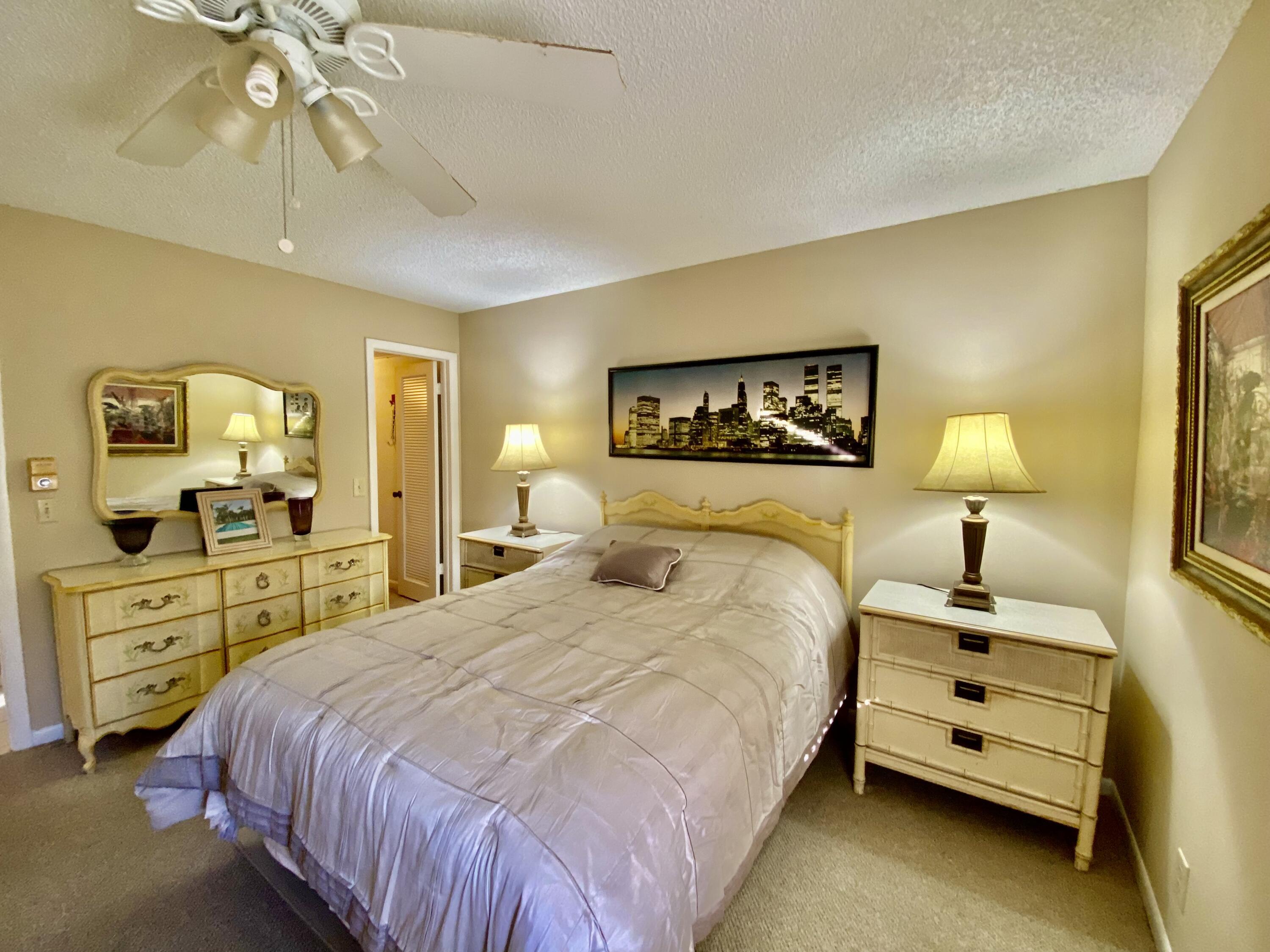 894 Flanders South Delray Beach, FL 33484 - Photo 11 of 21 a bedroom with a bed and a chandelier
