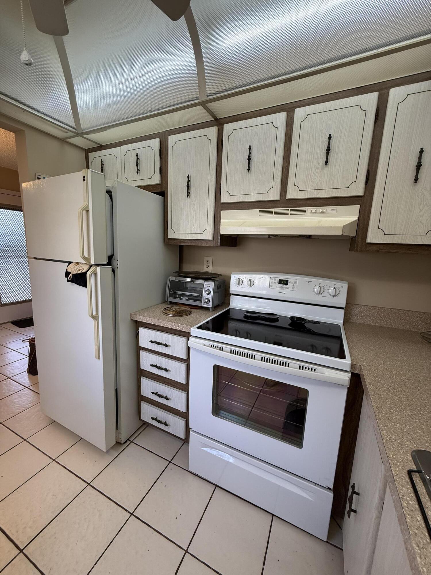 894 Flanders South Delray Beach, FL 33484 - Photo 2 of 16 a kitchen with appliances cabinets and a stove top oven