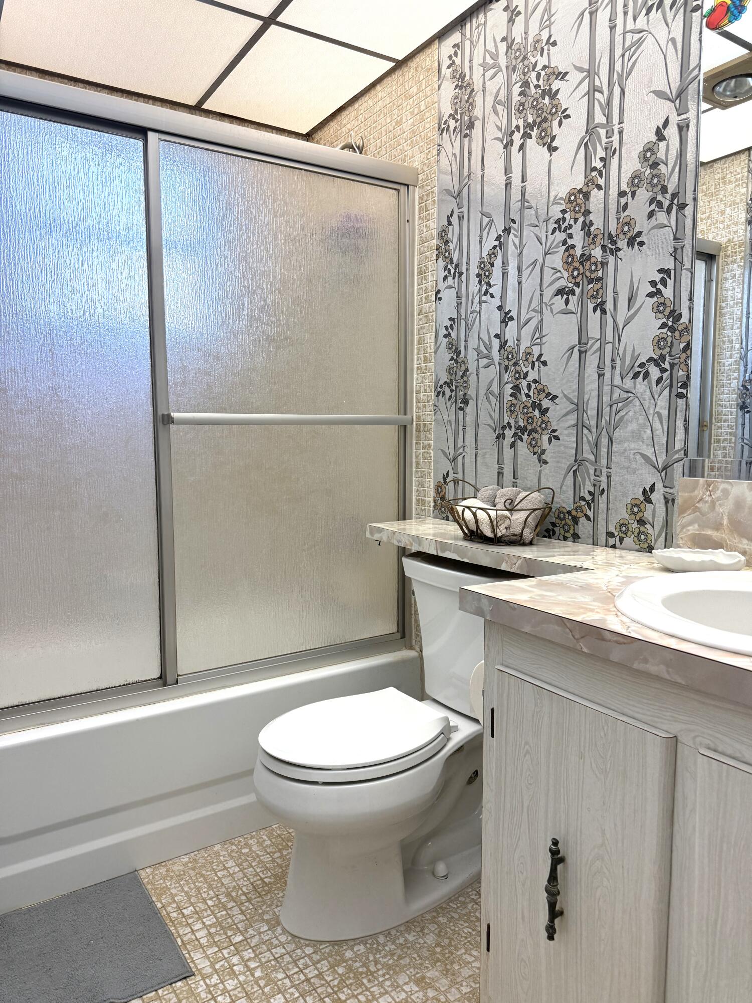 894 Flanders South Delray Beach, FL 33484 - Photo 9 of 21 a white toilet sitting next to a bathroom sink