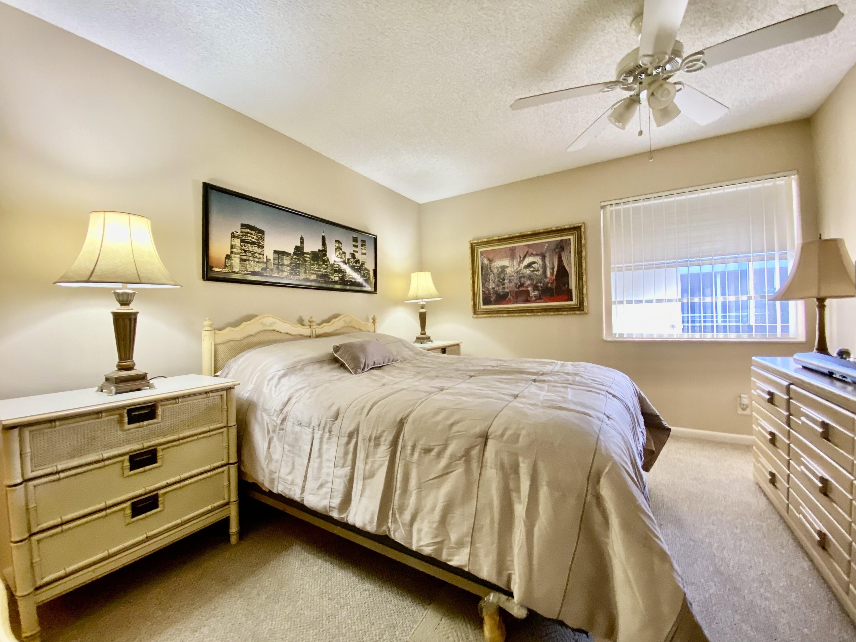 894 Flanders South Delray Beach, FL 33484 - Photo 10 of 21 a bed sitting in a bedroom and night stand