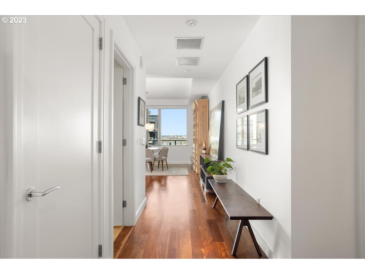 841 Southwest Gaines Street, Unit 1800 Portland, OR 97239 - Photo 2 of 39 a hallway with white cabinets and wooden floor