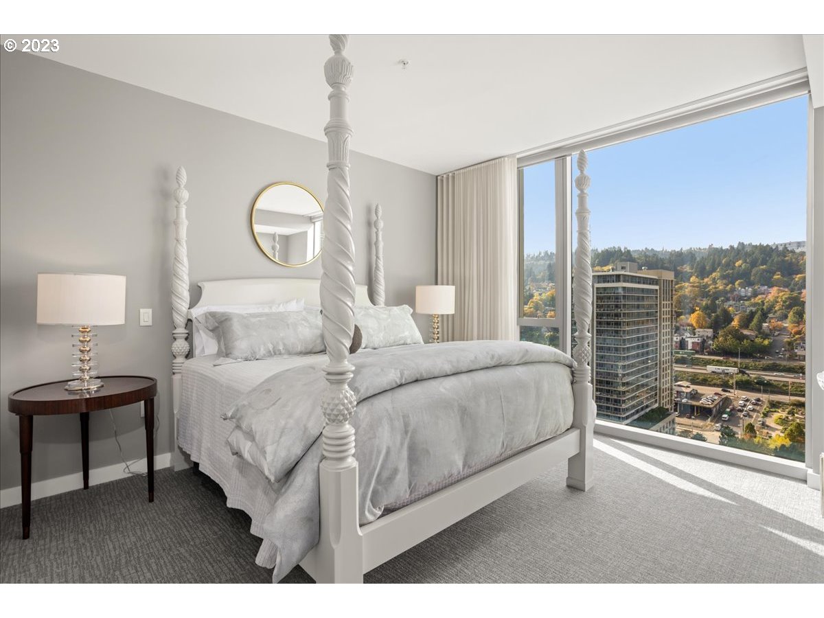 841 Southwest Gaines Street, Unit 1800 Portland, OR 97239 - Photo 23 of 39 a bedroom with a bed and a large window