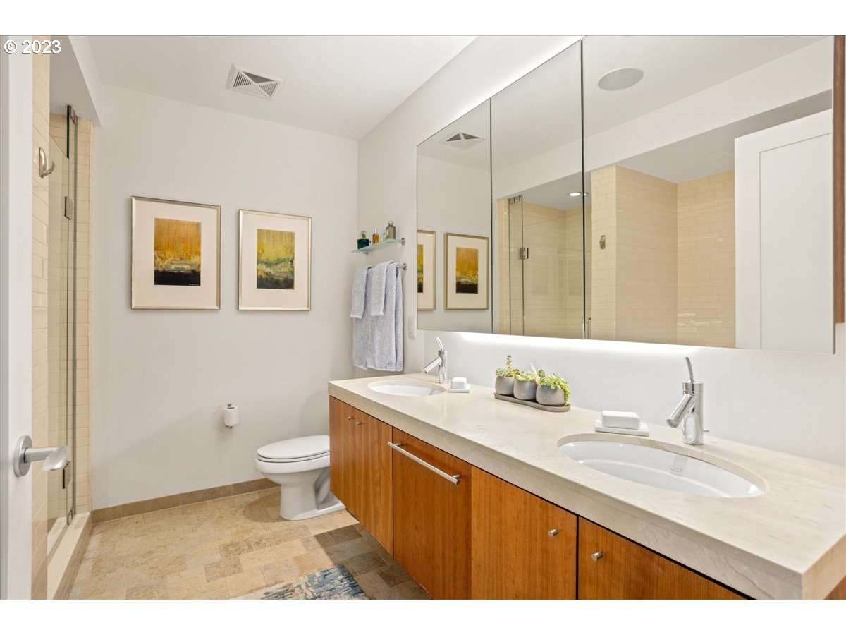 841 Southwest Gaines Street, Unit 1800 Portland, OR 97239 - Photo 27 of 39 a bathroom with a granite countertop sink toilet and shower