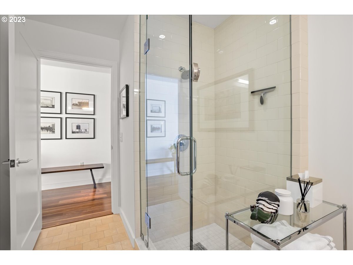 841 Southwest Gaines Street, Unit 1800 Portland, OR 97239 - Photo 32 of 39 a bathroom with a bathtub and a shower