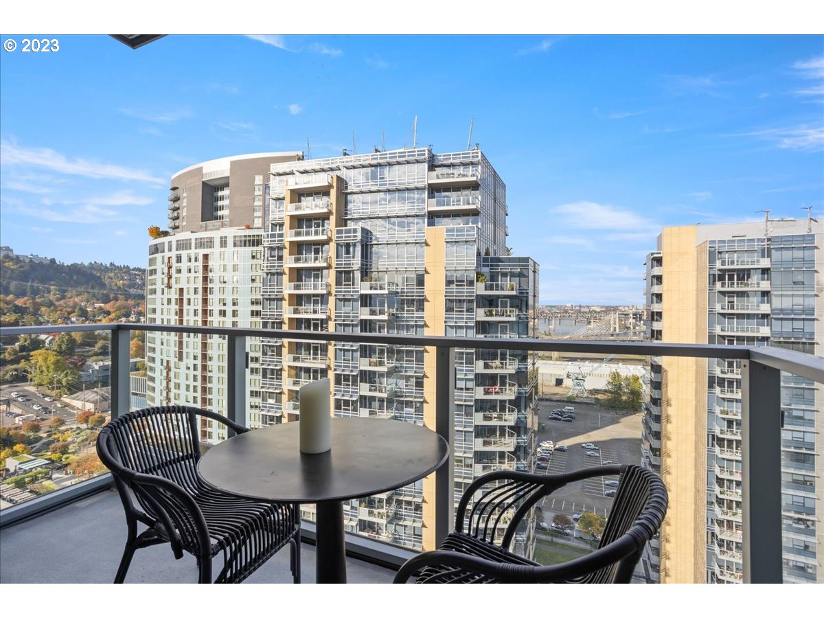 841 Southwest Gaines Street, Unit 1800 Portland, OR 97239 - Photo 6 of 39 a view of a balcony with a table and chairs