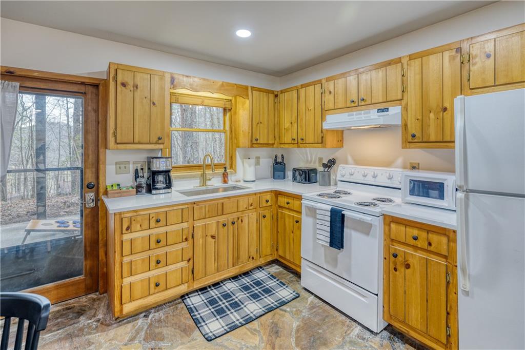 357 Mystic Lane Blue Ridge, GA 30513 - Photo 29 of 58 a kitchen with stainless steel appliances granite countertop a stove a sink and a refrigerator