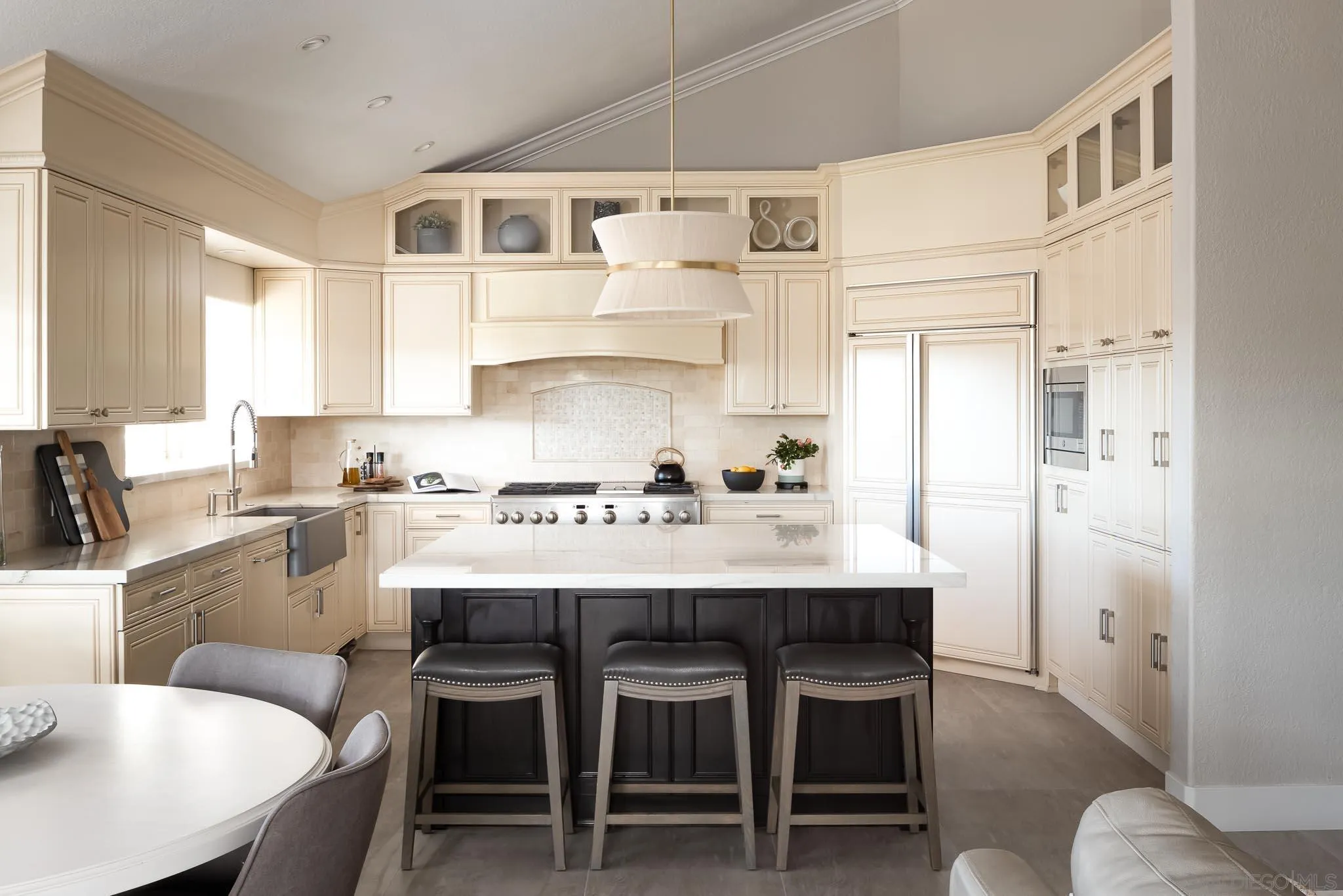 12645 Treehill Place Poway, CA 92064 - Photo 12 of 52 a kitchen with granite countertop a table chairs stove and cabinets