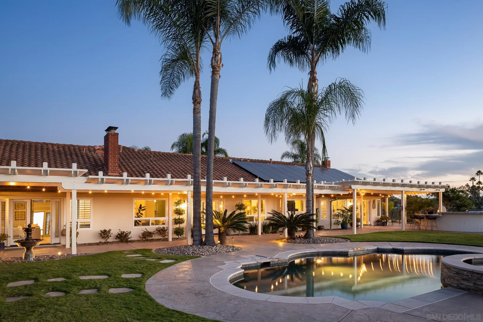 12645 Treehill Place Poway, CA 92064 - Photo 36 of 52 a view of a swimming pool with a table and chairs