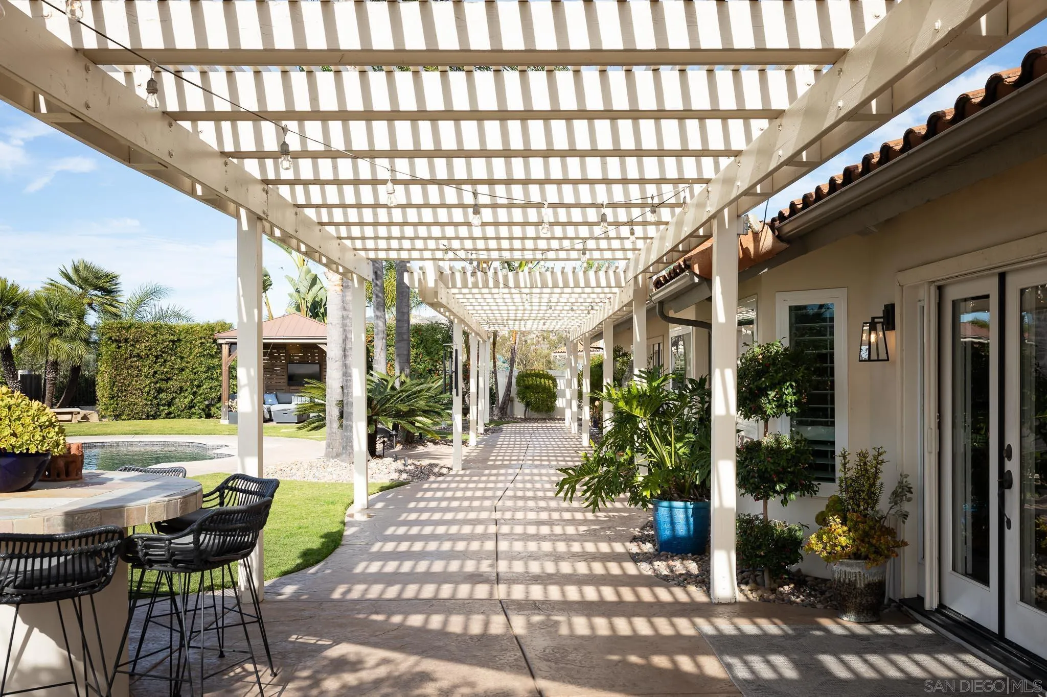 12645 Treehill Place Poway, CA 92064 - Photo 45 of 52 a view of a patio with a table and chairs