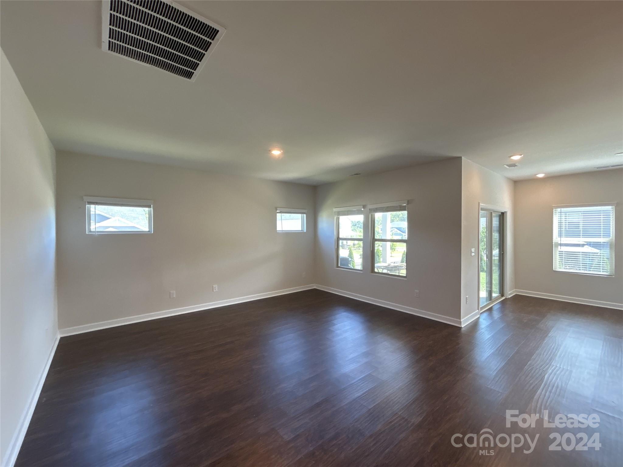 3801 Isenhour Road Kannapolis, NC 28081 - Photo 2 of 16 an empty room with wooden floor and windows