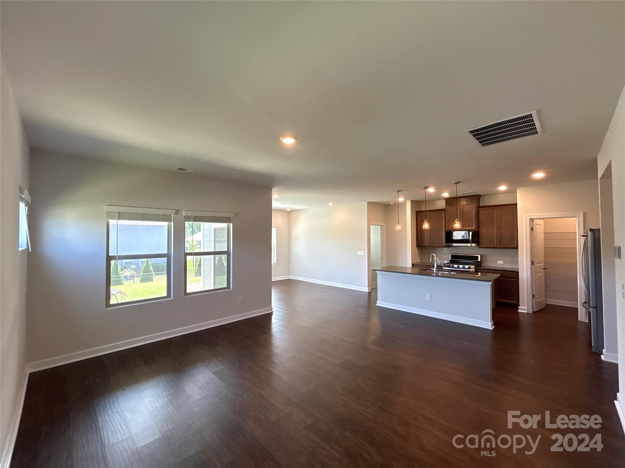 3801 Isenhour Road Kannapolis, NC 28081 - Photo 3 of 16 a view of an empty room with kitchen and window