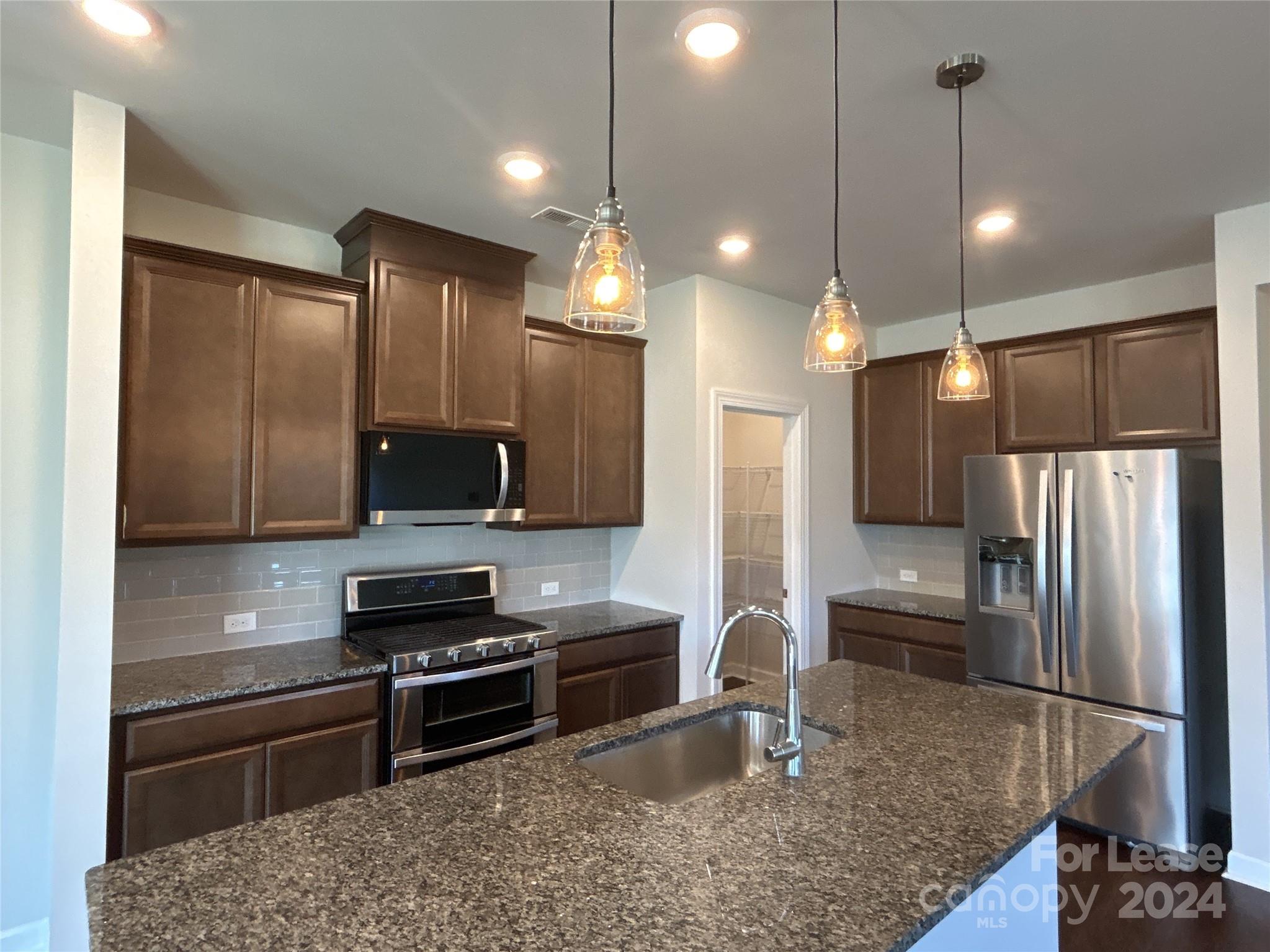 3801 Isenhour Road Kannapolis, NC 28081 - Photo 4 of 16 a kitchen with kitchen island a sink stainless steel appliances and cabinets