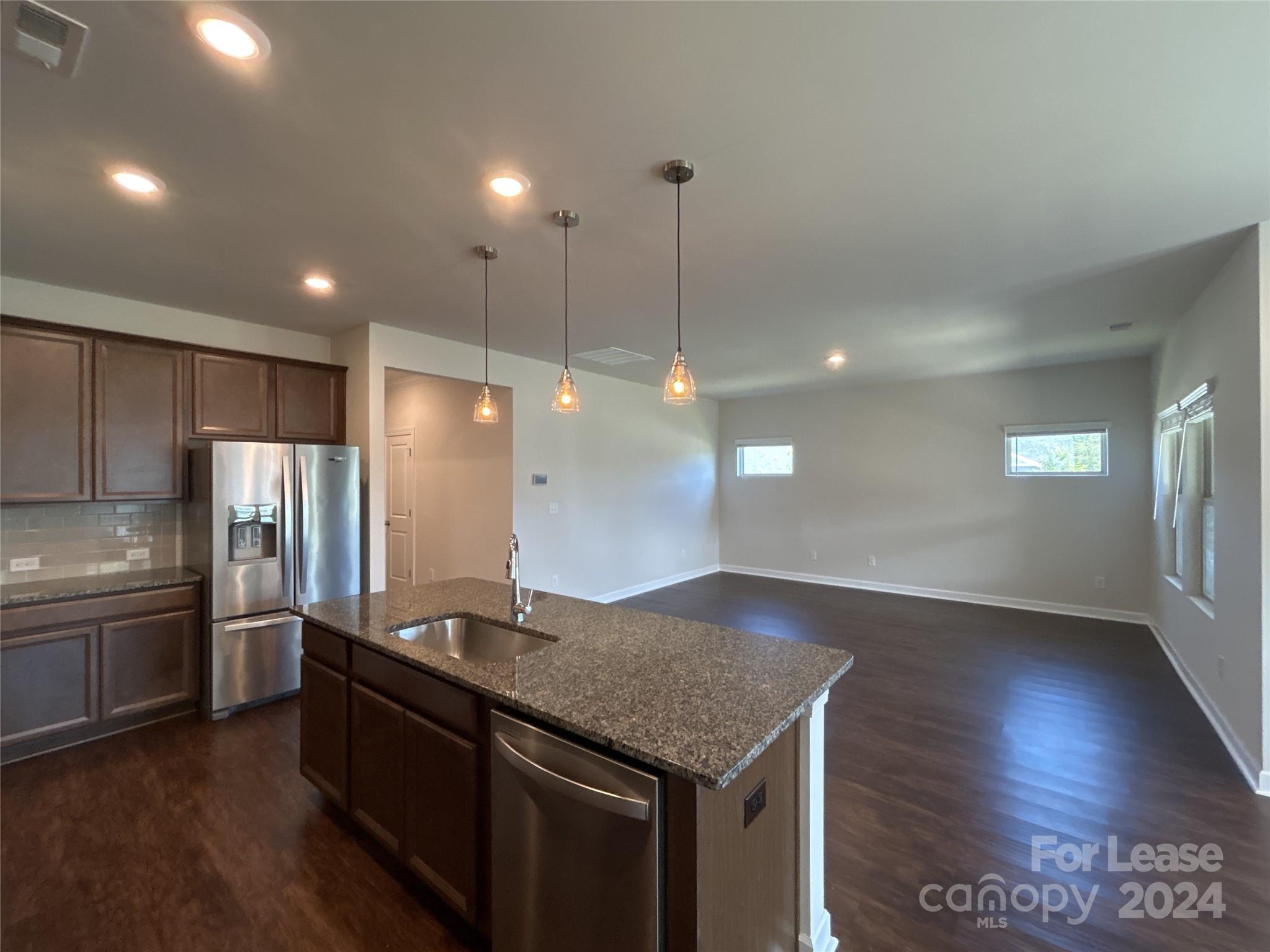 3801 Isenhour Road Kannapolis, NC 28081 - Photo 5 of 16 a kitchen with stainless steel appliances granite countertop a refrigerator a sink and a stove