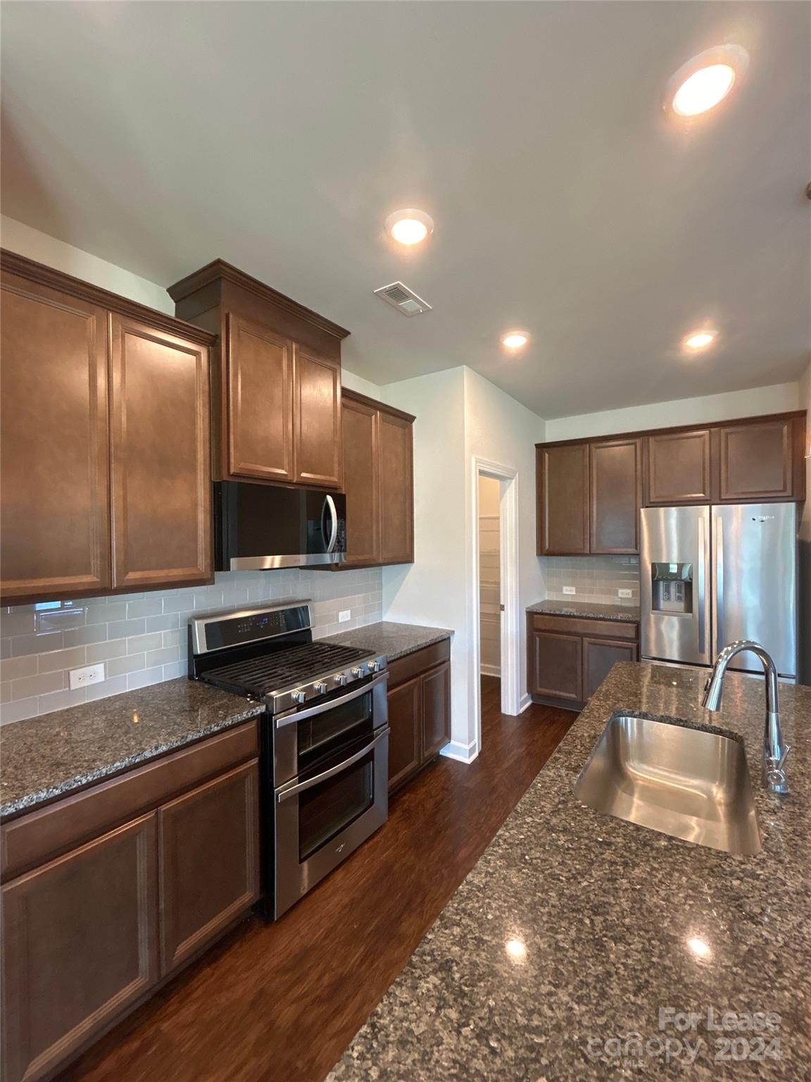 3801 Isenhour Road Kannapolis, NC 28081 - Photo 6 of 16 a kitchen with stainless steel appliances granite countertop a stove a sink and a microwave