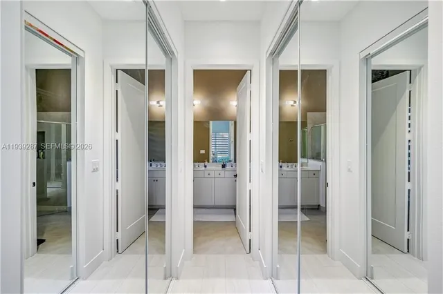 a bathroom with a glass shower door and a mirror