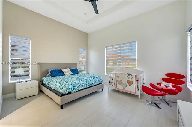 a bedroom with a bed and a lounge chair