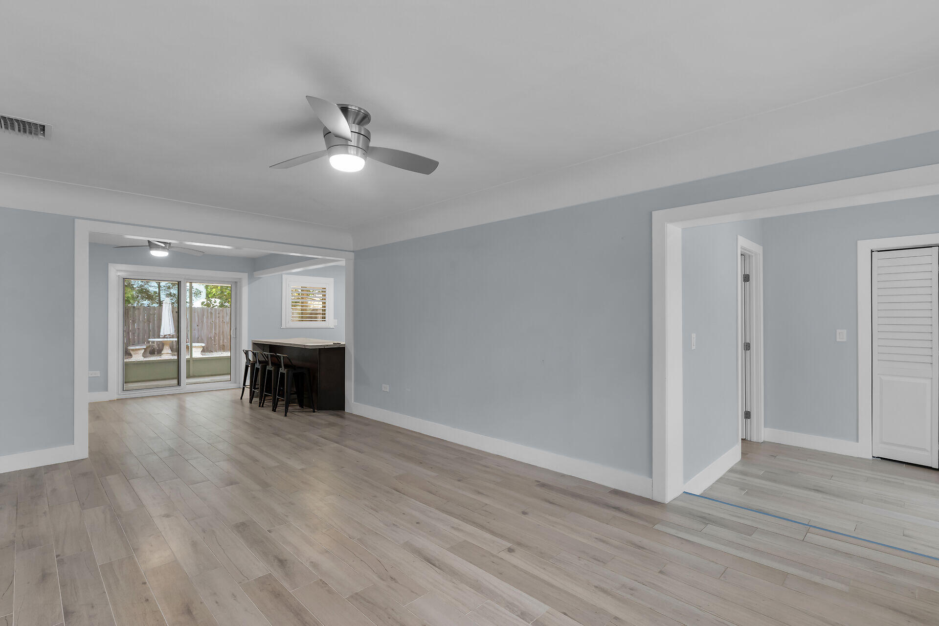 535 Plante Street Key Largo, FL 33037 - Photo 13 of 47 a view of an empty room with wooden floor fireplace and a window
