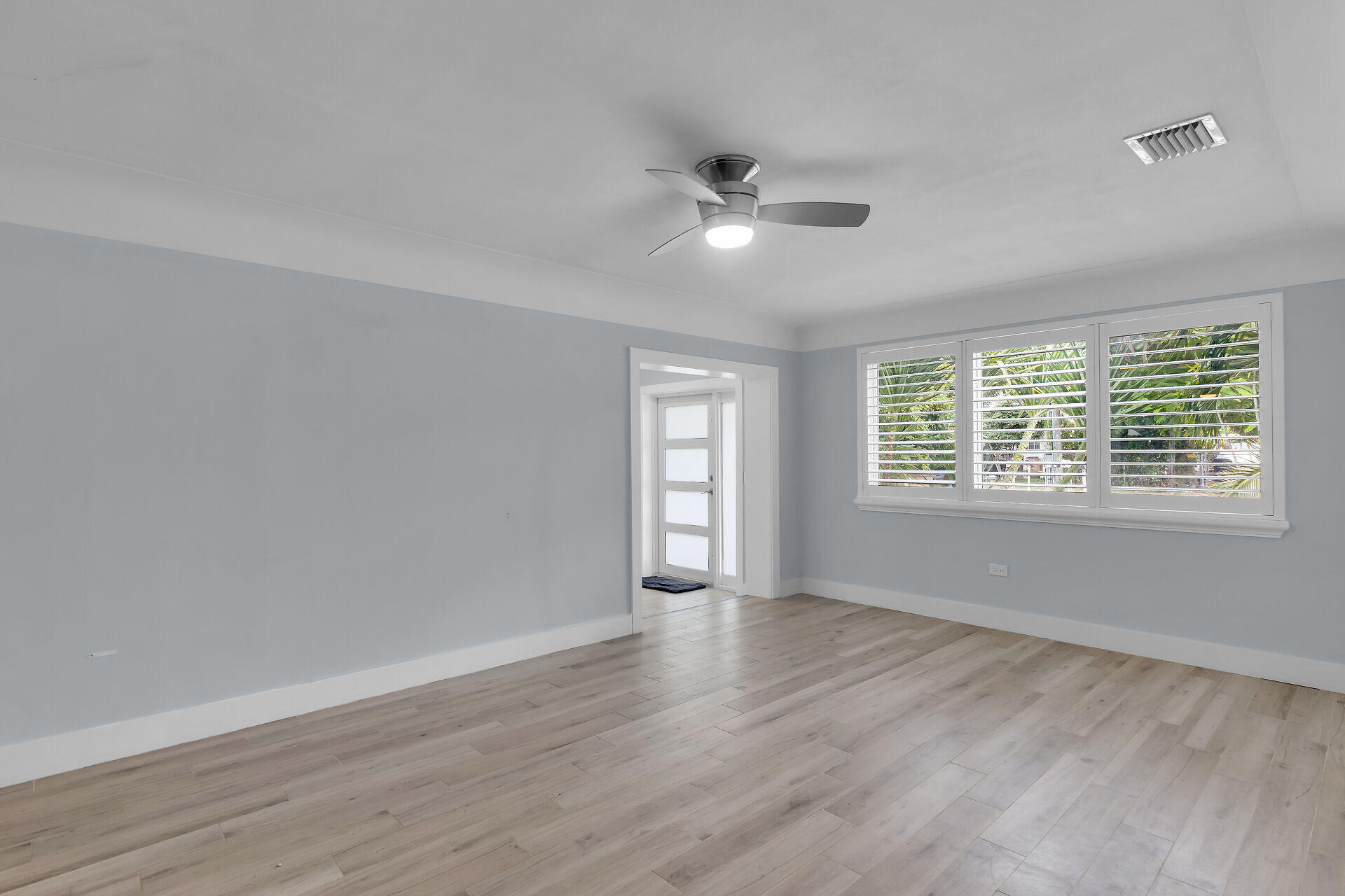 535 Plante Street Key Largo, FL 33037 - Photo 14 of 47 a view of an empty room with wooden floor and a window