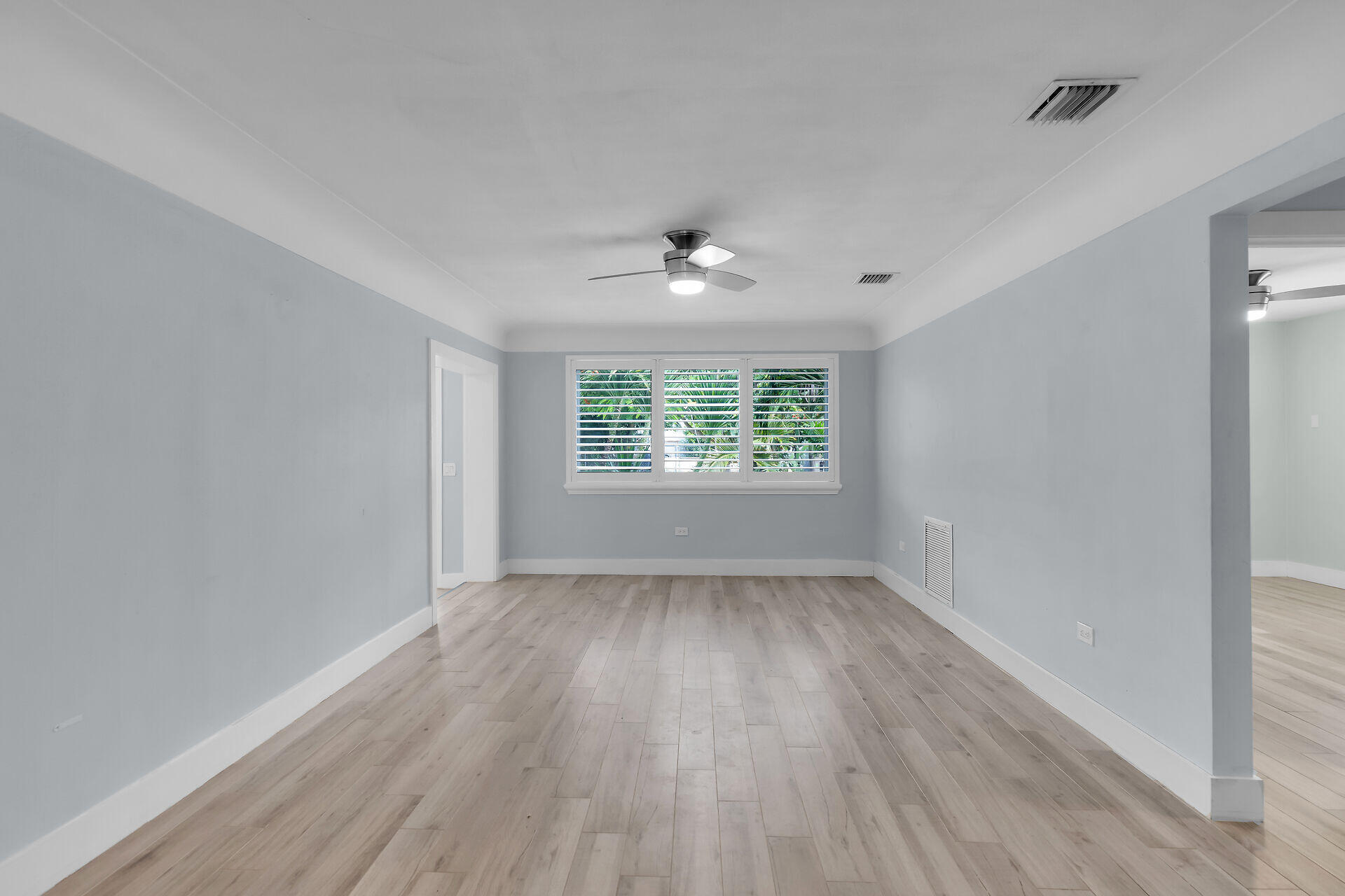 535 Plante Street Key Largo, FL 33037 - Photo 15 of 47 an empty room with wooden floor chandelier fan and windows