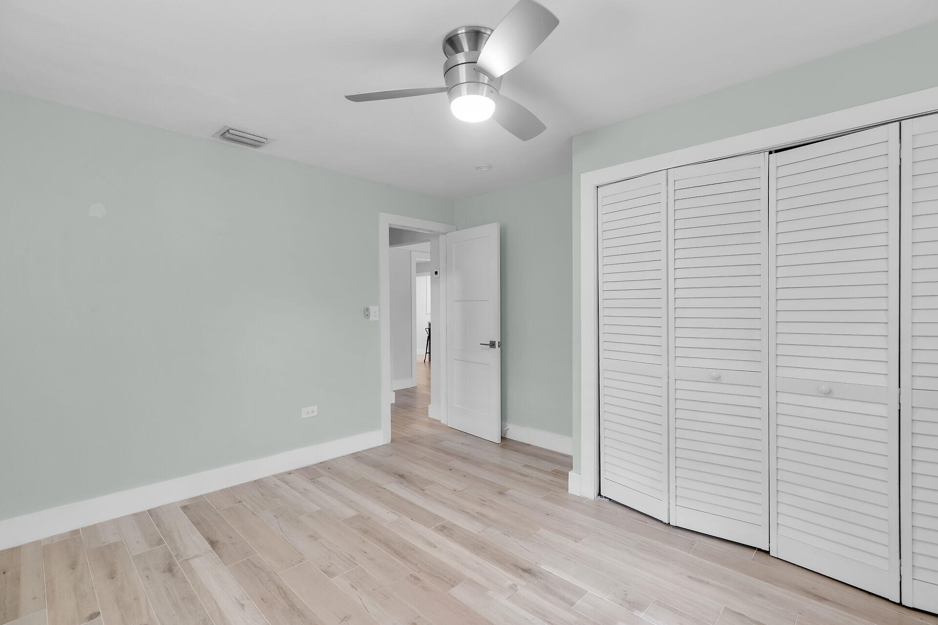535 Plante Street Key Largo, FL 33037 - Photo 28 of 47 a view of a room with wooden floor and a ceiling fan