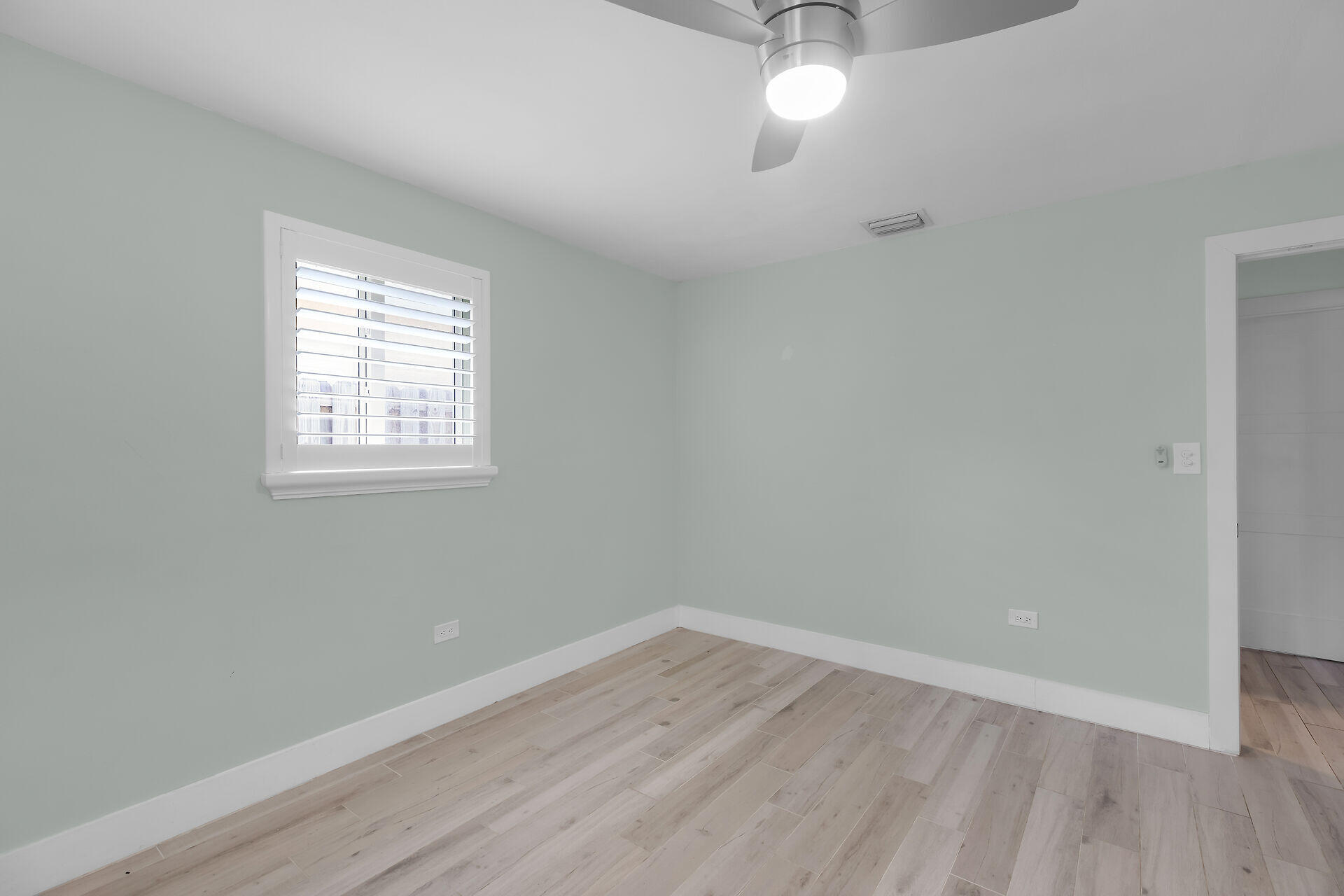 535 Plante Street Key Largo, FL 33037 - Photo 29 of 47 an empty room with wooden floor and windows
