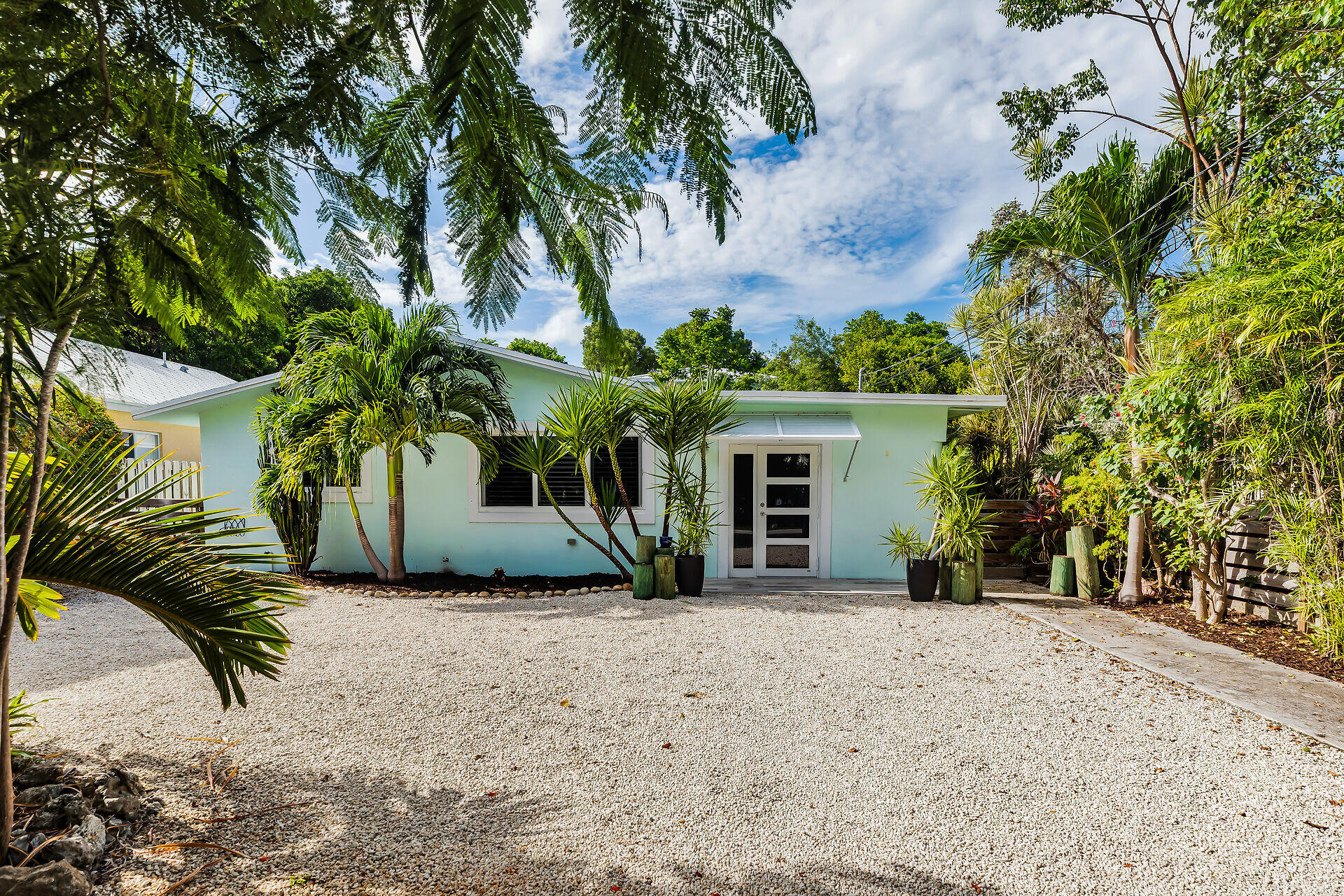 535 Plante Street Key Largo, FL 33037 - Photo 47 of 47 a view of a house with a yard and garage